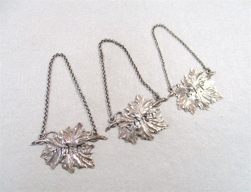 Lot 357 - A pair of William IV silver decanter labels and another Victorian silver label to match