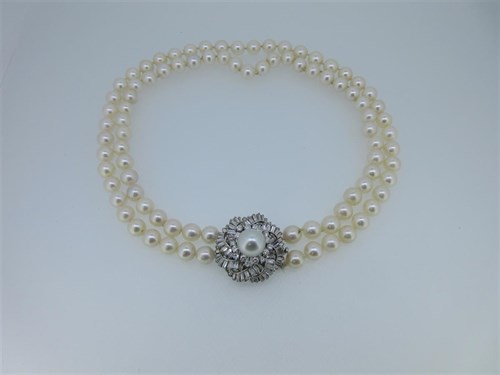 Lot 211 - A two row cultured pearl necklace with removable diamond and pearl clasp / brooch
