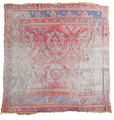 Lot 515 - A faded Ushak rug