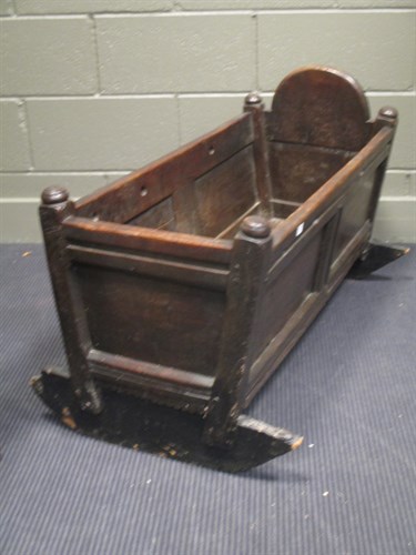 Lot 450 - A Jacobean panelled oak rocking cradle, 93cm long