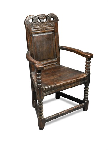 Lot 514 - A 17th century and later carved 'Cacqueteuse' wainscot armchair