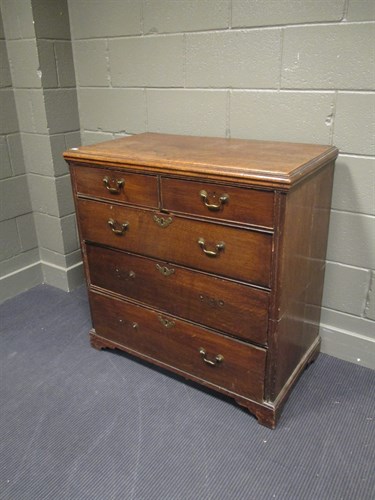 Lot 423 - A Georgian oak chest of three long and two...