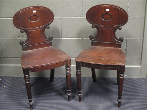 Lot 470 - A pair of late Georgian mahogany hall chairs...