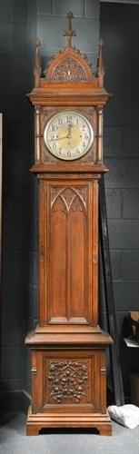 Lot 483 - A late Victorian Gothic carved oak chiming longcase clock