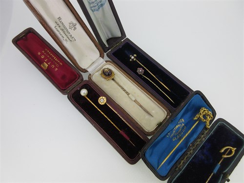 Lot 63 - A diamond set stick pin together with a collection of six others