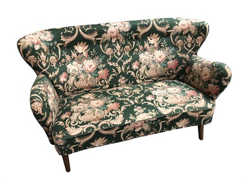Lot 161 - In the manner of Finn Juhl, a small wing back two-seat sofa