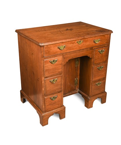 Lot 627 - A George III 'red walnut' kneehole desk