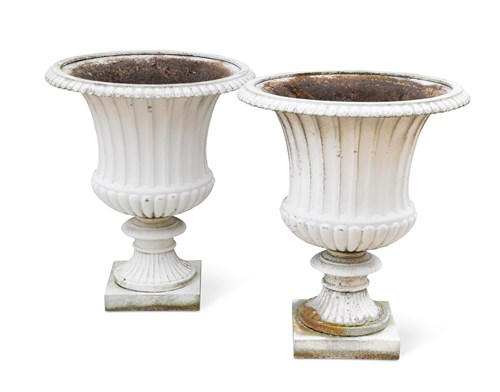 Lot 677 - A pair of cast iron campana shape garden urns
