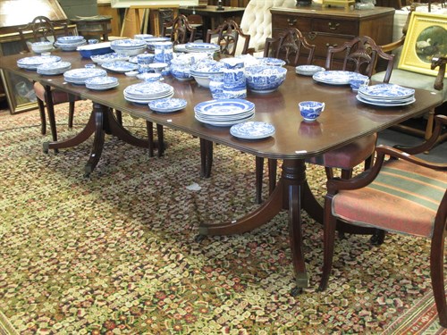 Lot 421 - A mahogany twin pedestal dining table with two...