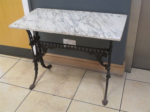 Lot 499 - A marble top table with cast iron base 71 x 92...