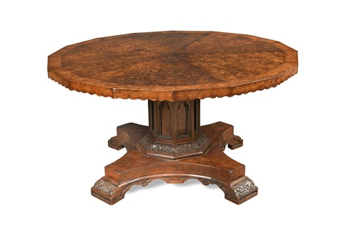 Lot 653 - A Gothic revival figured oak pedestal centre table in the manner of Pugin