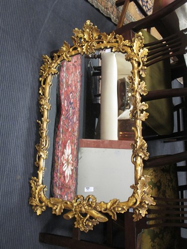 Lot 480 - A gilt framed wall mirror of branch and acorn...