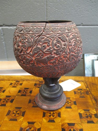 Lot 244 - A carved coconut shell on stand