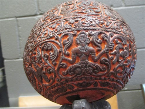 Lot 244 - A carved coconut shell on stand