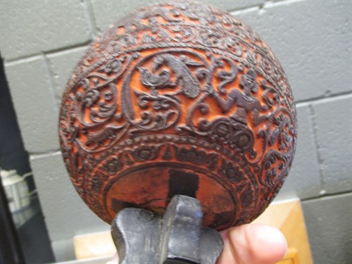 Lot 244 - A carved coconut shell on stand