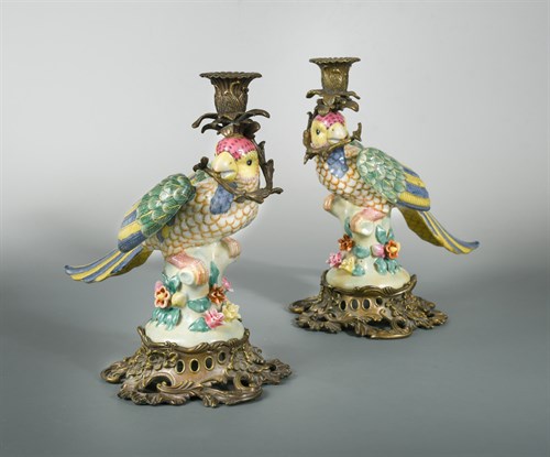 Lot 440 - A pair of gilt metal mounted porcelain parrot candlesticks
