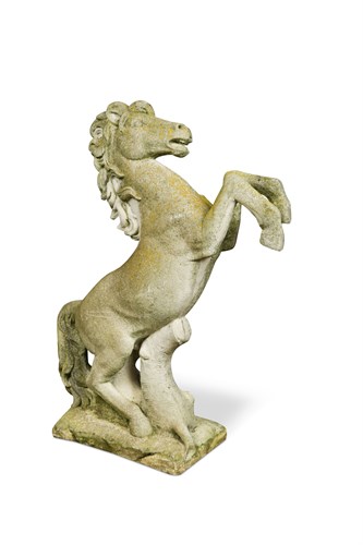 Lot 700 - A reconstituted stone figure of a prancing horse