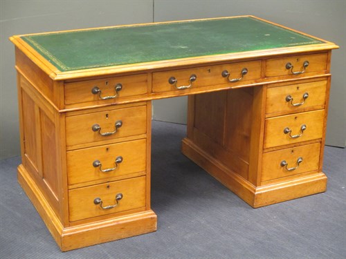 Lot 418 - A pale wood twin pedestal desk, with official...
