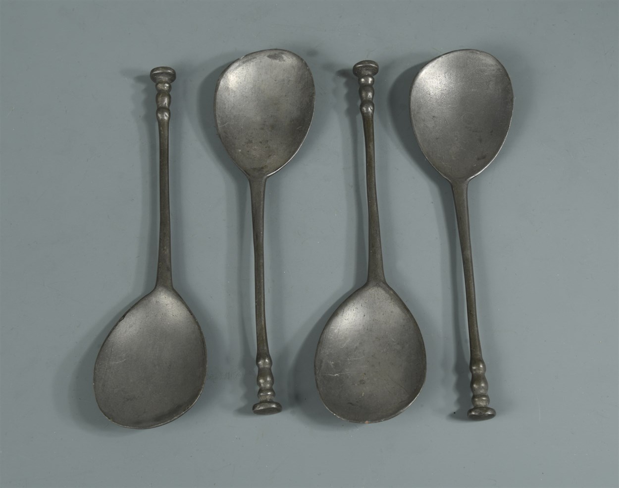 Lot 386 - A set of four pewter spoons
