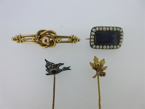 Lot 90 - A Georgian lace pin, a flying duck stick pin, and two others