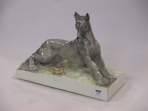 Lot 211 - A Continental  Goldscheider style model of a dog & a lizard