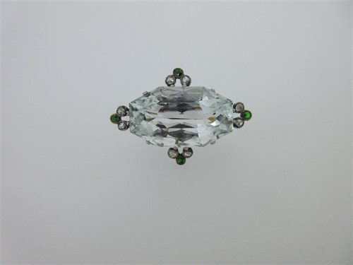 Lot 134 - An Art Deco aquamarine brooch with diamond and demantoid garnet highlights