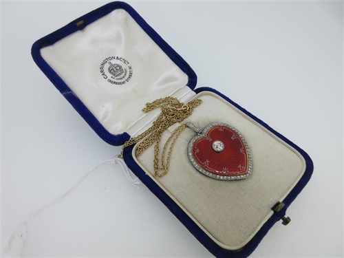 Lot 75 - A guilloche enamel and diamond heart shaped pendant locket