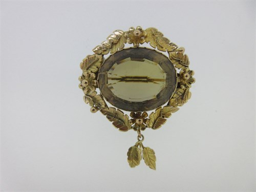 Lot 25 - A Victorian smoky citrine brooch with foliate and floral mount