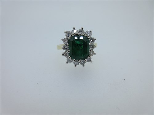 Lot 240 - An 18ct gold emerald and diamond cluster ring