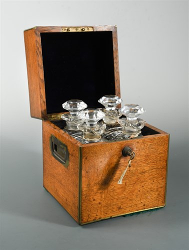 Lot 406 - A 19th century oak decanter box and decanters