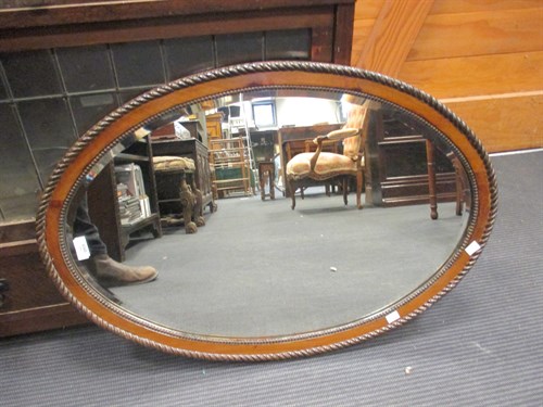 Lot 456 - An oval mahogany mirror, 78 x 53cm