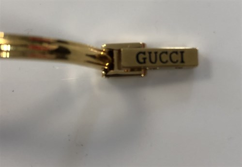 Lot 270 - Gucci - A lady's gold plated bangle watch