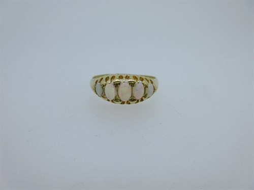 Lot 94 - A navette shaped ring set with five opals