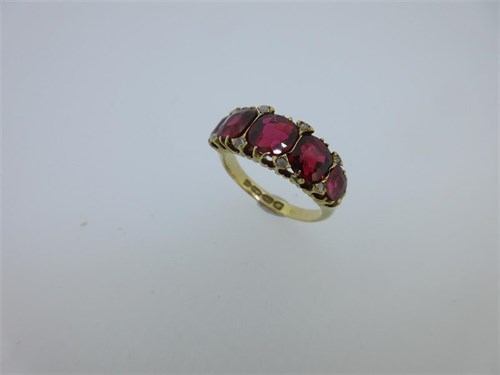 Lot 184 - A Victorian 18ct gold ring set with garnet-topped doublets and diamond highlights