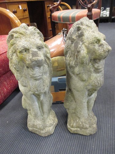 Lot 522 - A pair of reconstituted stone lions, 52cm high...
