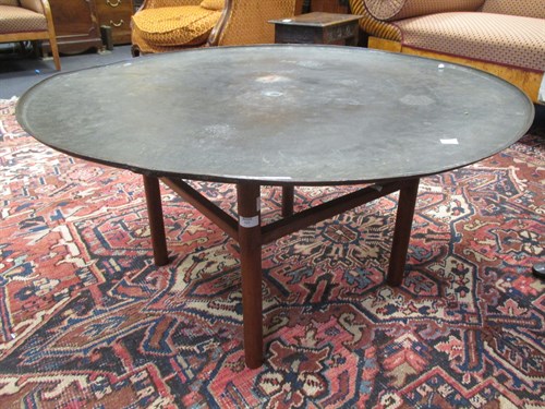 Lot 589 - A Middle Eastern turned brass circular table...