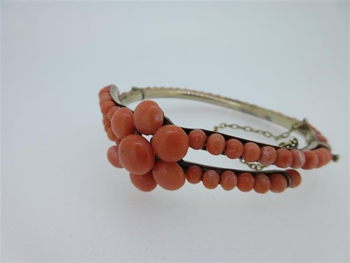 Lot 84 - A vintage coral set hinged bangle - probably Dutch