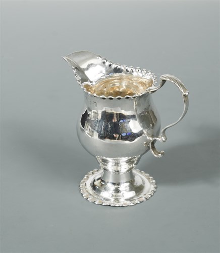Lot 335 - A George III silver cream jug