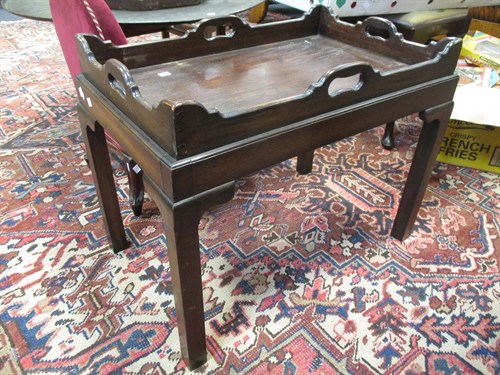 Lot 586 - A mahogany butler’s tray design coffee table...