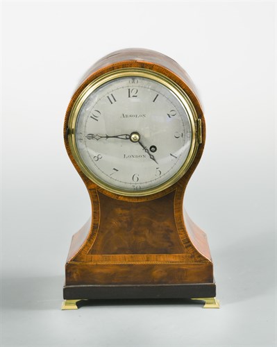 Lot 437 - A Regency mahogany and cross-banded balloon mantel timepiece