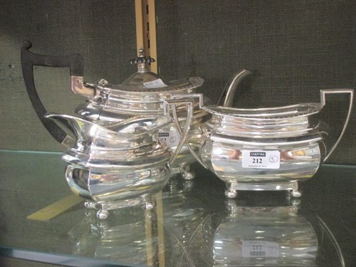Lot 212 - A silver three piece tea set by Walker and...