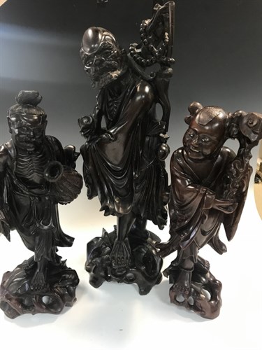 Lot 12 - Three Chinese rosewood figures, Late Qing...