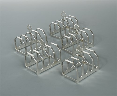 Lot 420 - A set of five George V silver toast racks