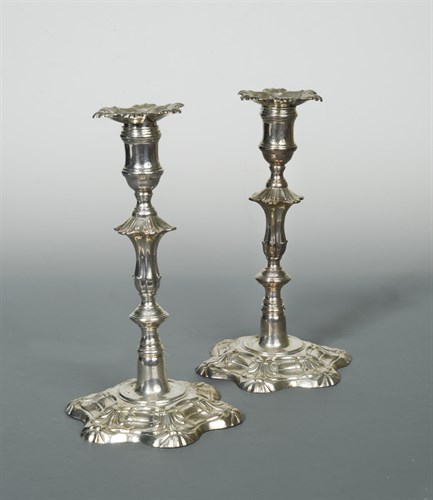 Lot 328 - A pair of George II cast silver candlesticks