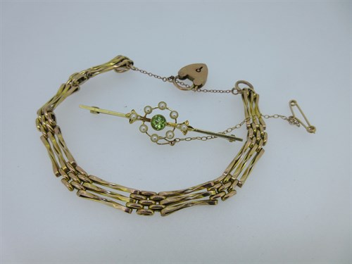 Lot 210 - A peridot and seed pearl bar brooch together with a gatelink bracelet