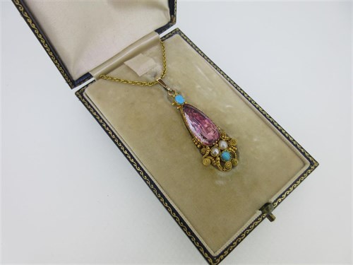 Lot 198 - An early 19th century foiled rock crystal, turquoise and pearl pendant with chain, in fitted case