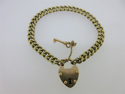 Lot 148 - A curb link bracelet and associated heart locket clasp with working key, both marked '15ct'