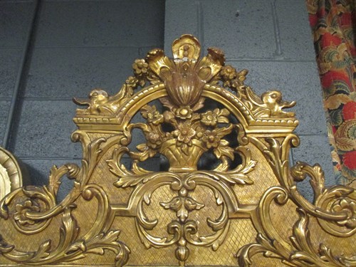 Lot 563 - A rectangular gilt framed wall mirror with...