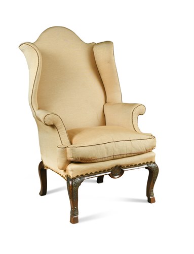 Lot 594 - A Queen Anne walnut and brass mounted wing back armchair