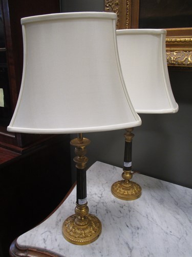Lot 632 - A pair of brass two branch wall lights 57 cm...
